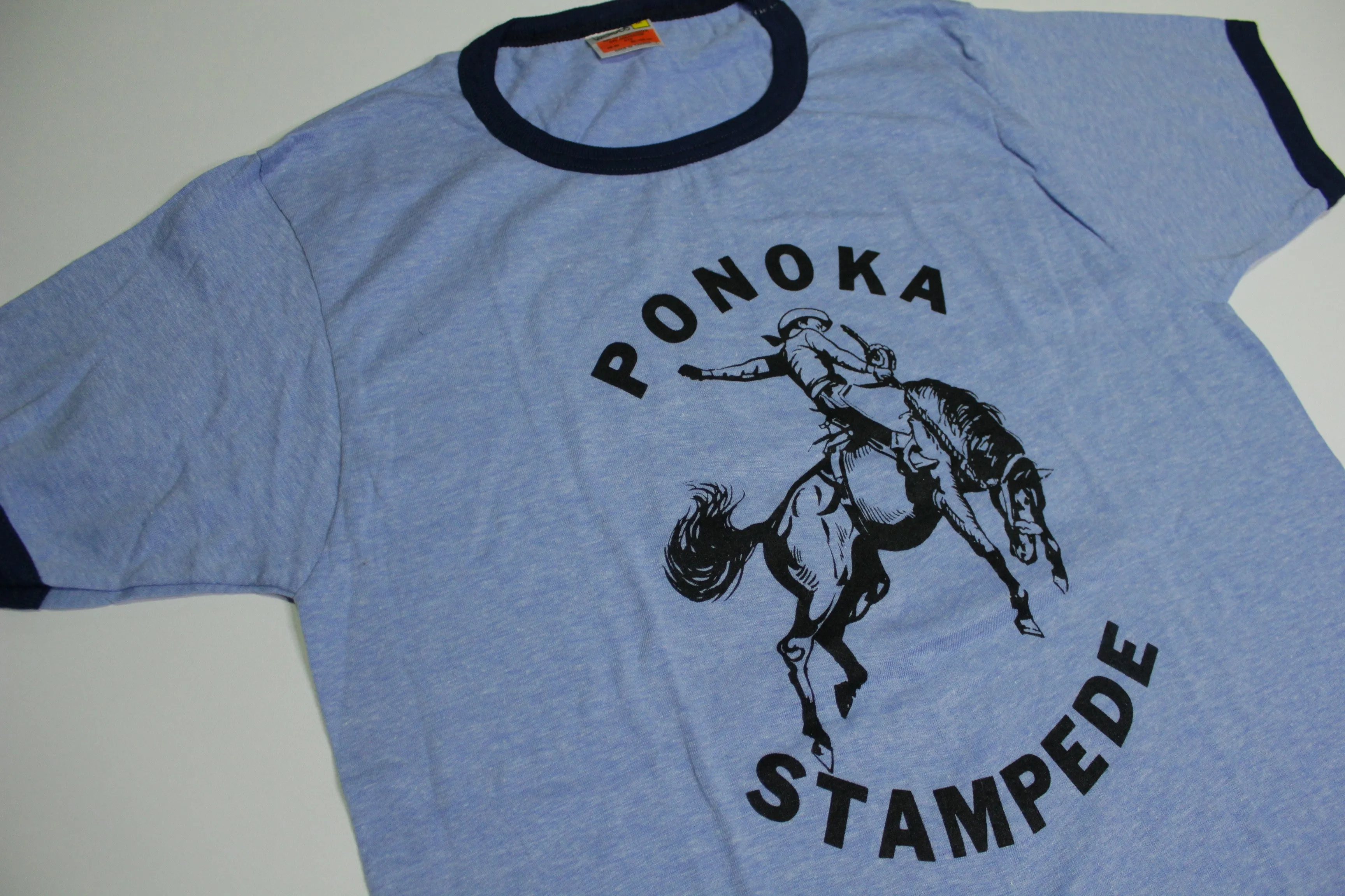 Sure! Here’s an optimized title for your e-commerce product:

Vintage 1980s Ponoka Stampede Ringer T-Shirt - Classic Harvey Woods Rodeo Tee from Alberta, Canada

This title includes key attributes like the vintage aspect, decade, event name, type of shirt, and geographical location, making it more appealing for search optimization.